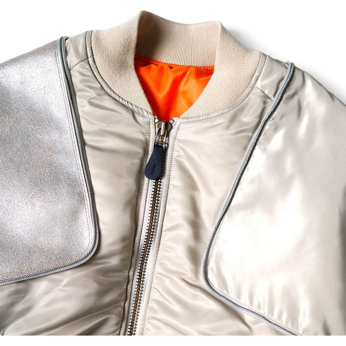 Silver jacket with orange lining on a white background