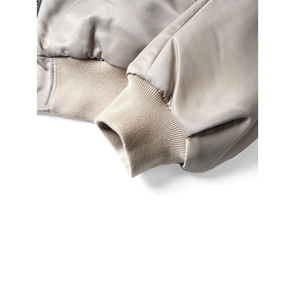 Close-up of a beige jacket with a white background